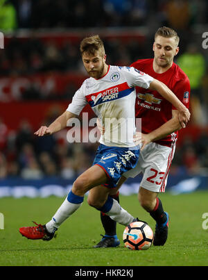 Wigan Athletic Michael Jacobs (links) und Manchester United Luke Shaw kämpfen um den Ball in den Emiraten FA Cup, vierten Vorrundenspiel im Old Trafford, Manchester. Stockfoto