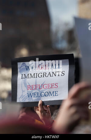 Boston, Massachusetts, USA. 29. Januar 2017.  Mehr als 20.000 Demonstranten gefüllt Copley Square in Zentral-Boston Protest gegen Präsident Donald Trump Ausführungsverordnung gestoppt Einwanderung aus Iran, Irak, Jemen, Somalia, Sudan, Libyen und Syrien in den Vereinigten Staaten.  Foto zeigt eine Hand mit einem kleinen Protest Schild Einwanderer zu unterstützen.   Die Demonstration am Copley Square wurde organisiert von der Massachusetts-Zweig des Council on American-Islamic Relations, CAIR.  Bildnachweis: Chuck Nacke/Alamy Live-Nachrichten Stockfoto