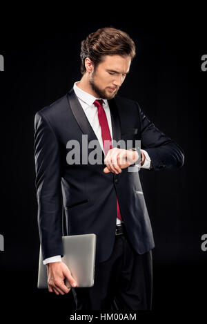 Gut aussehend Kaufmann Holding laptop Stockfoto