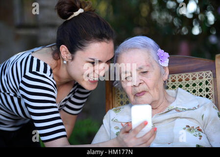 Enkel Oma lernen Unterricht verwenden weißen smartphone Stockfoto