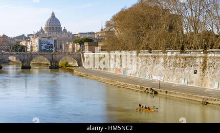 Ein Blick auf St. Peter-Basilika, die über den Tiber von Pont St. Angelo in Rom gesehen, wie ein kleines Ruderboot geht Stockfoto