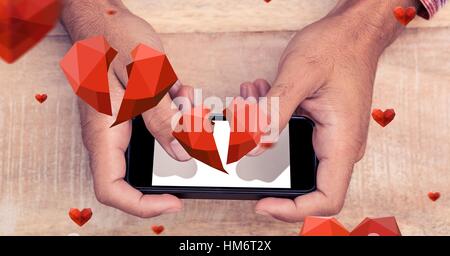 Zusammengesetztes Bild von Hand mit Handy Stockfoto