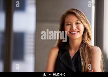 Junge asiatische Geschäftsfrau lächelnd zu Kamera, Nahaufnahme Stockfoto