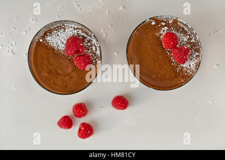 Hausgemachte Schokoladen-Mousse mit frischen Himbeeren auf einem Tisch, Seitenansicht. Stockfoto