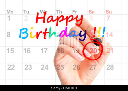 Happy birthday bunt Text und eine Frau Hand kreisen ein Datum im Kalender Stockfoto