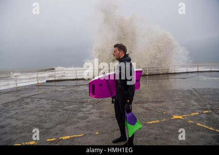 Aberystwyth, Ceredigion, Wales, UK. 3. Februar 2017. Großbritannien Wetter. Hochwasser und starker Wellengang Atlantic bringen heute Morgen große Wellen, die in die Promenade und Meer Abwehr in Aberystwyth an der Westküste von Wales. Eine mutige Körper-Boarder nutzt die Gelegenheit des Reitens, die einige der großen 10' hohe Wellen wie sie in der Nähe von Aberystwyth Hafen potenziell schädliche Gales, brechen mit Böen von mehr als 60 km/h dürften Streikrecht Teile des südlichen UK heute Photo Credit: Keith Morris/Alamy Live News Stockfoto