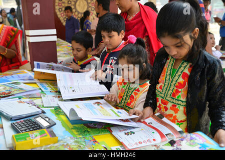 Dhaka, Bangladesch. 3. Februar 2017. Bangladeshi Kind Shopper durchsuchen Bücher in einem Stall während des Landes größte Buchmesse in Dhaka, Bangladesch. Am 3. Februar 2017. Bangladesch die größte Buchmesse begann in Dhaka ab dem 1. Februar mit Polizei Warnung Veranstalter gegen den Verkauf von Büchern, die "religiöse Gefühle" in dem mehrheitlich muslimischen Land verletzt. Der einmonatigen Ekushey Buchmesse zieht Hunderttausende Besucher in die überfüllten Hauptstadt eines Bangladeshs Keynote Kulturveranstaltungen und dem Leser eine Chance, mit den Autoren zu interagieren. Bildnachweis: Mamunur Rashid/Alamy Live-Nachrichten Stockfoto