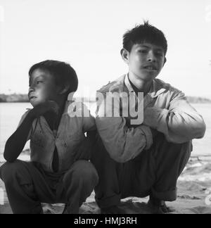 Jungen Hocken bin Strang Bei Canaima Venezuela 1966. Jungs hocken am Strand in der Nähe von Canaima (Venezuela), 1966. Stockfoto