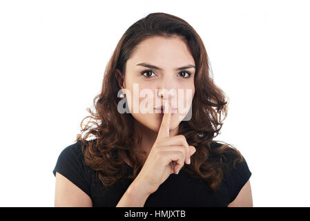 junge Frau mit Finger, Lippen, isoliert auf weiss Stockfoto