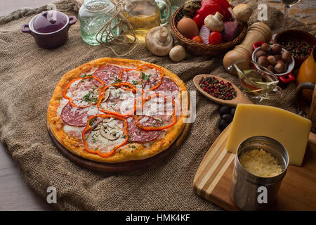Leckere italienische Pizza serviert auf Sackleinen Stockfoto