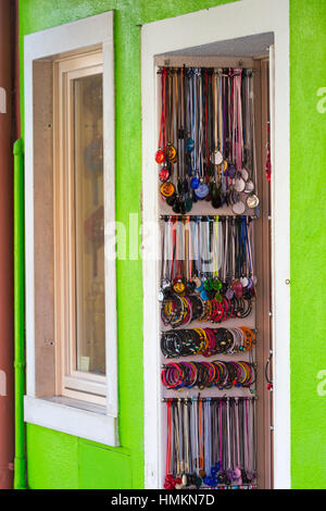 Armbänder und Ketten hängend auf dem Display in der Tür am Burano, Venedig, Italien im Januar Stockfoto