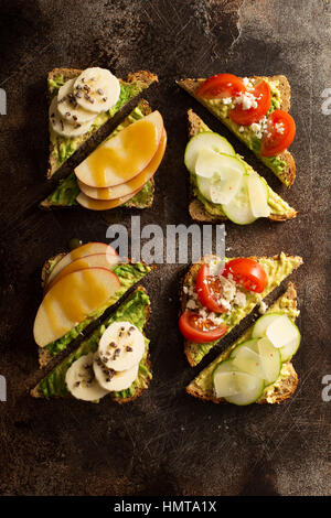 Avocado-Toast mit verschiedenen Früchten und Gemüse Belag Stockfoto