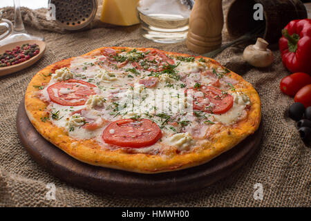 Pizza mit Schinken Käse und Tomaten Stockfoto