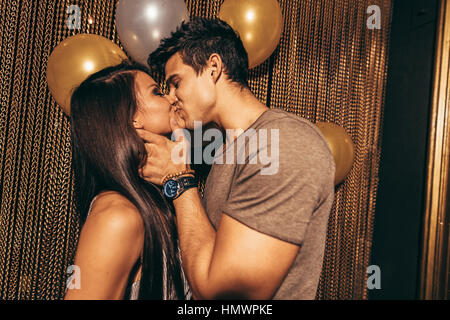 Schuss des romantischen junge Paar küssen im Night Club. Mann und Frau in der Kneipe. Stockfoto