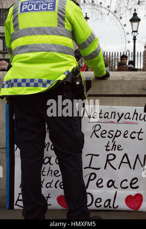 London, UK. 6. Februar 2017. Ein Polizist steht vor der ein Plakat als pro-palästinensische gegen Premierminister von Israel, Benjamin Netanyahu demonstrieren Besuch von Downing Street. Bildnachweis: Thabo Jaiyesimi/Alamy Live-Nachrichten Stockfoto