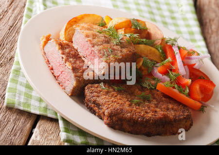 Panierte Rindernuss und als Beilage Gemüse Nahaufnahme auf einer Platte. horizontale Stockfoto