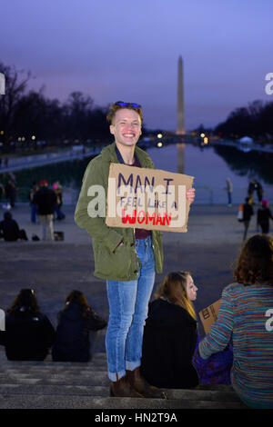 Ein Mann hält ein Schild mit der Aufschrift "Mann, ich fühle wie eine Frau auf der Mall mit dem Washington Monument in Ferne bei der Frauen Marsch auf Washington, DC" Stockfoto