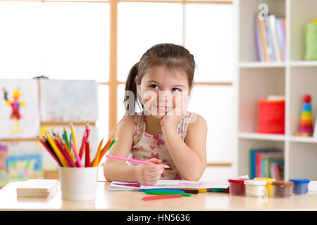 Lächelndes Kind Mädchen zeichnen mit Farbstiften in Kita Stockfoto