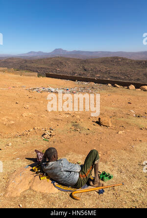 Äthiopischen Mann Kauens Khat vor einem Tal, Oromia, Babile, Äthiopien Stockfoto