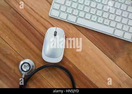 Nahaufnahme des Stethoskop mit Tastatur und Maus auf Tisch Stockfoto