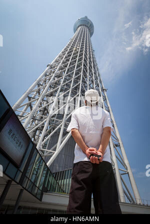 Tokio - 26.Mai: A Mann schaut sich den Tokyo Skytree in Japans Hauptstadt. Die Skytree für die Öffentlichkeit am 22. Mai 2012 eröffnet, es ist der höchste Turm Stockfoto