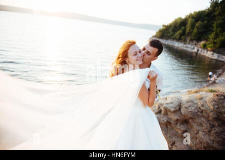 schöne schöne blonde Braut und Bräutigam stilvoll auf den Felsen, ami Stockfoto