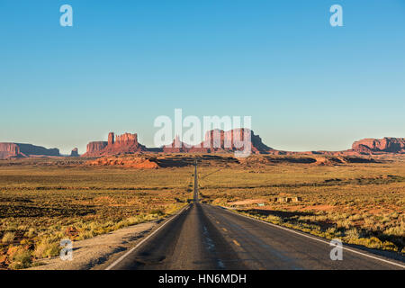 Blick auf Monument Valley Schluchten bei Sonnenaufgang mit Straße in Arizona Stockfoto