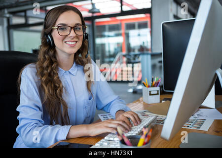 Porträt von weiblichen Grafik Designer arbeiten über Computer am Schreibtisch im Büro Stockfoto