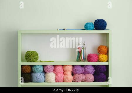 Colorful Balls Of Wool On Shelves. Variety of knitting yarns. Different Yarn balls in multiple colors. Yarn Storage. Stockfoto
