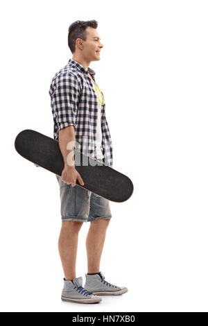 Voller Länge Profil Schuss ein Skater hält eine Skateboard und in der Schlange isoliert auf weißem Hintergrund Stockfoto
