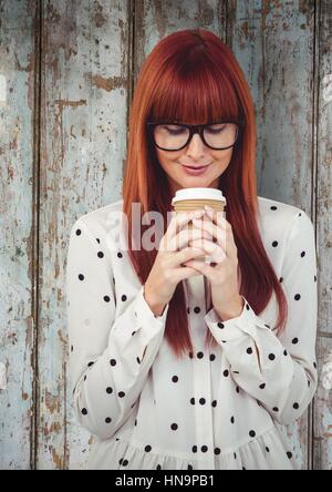 Digital Composite Frau mit Kaffee gegen Holzplatte Stockfoto