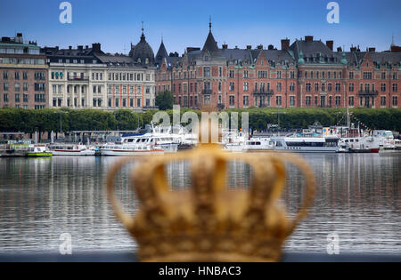 STOCKHOLM, Schweden - 20. August 2016: Skeppsholmsbron (Skeppsholm Brücke) goldene Krone auf einer Brücke mit Blick auf Östermalm mit Trastevere Boote in Stockfoto