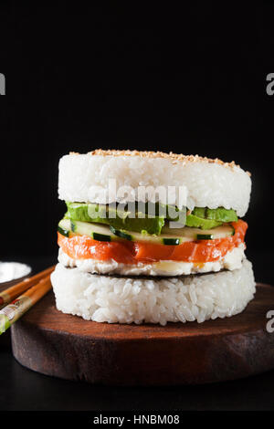 Sushi-Menü mit Burger aus Reis und geräucherter Lachs, Avocado, leichte Käse und nori Stockfoto