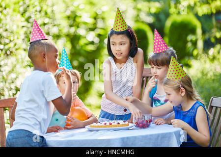 Interracial Gruppe von Kindern feiern Geburtstag Party mit Kuchen Stockfoto