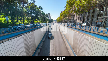 Sonne scheint hell auf Calle del Alfonso wo es einen Tunnel, der unter einer Kreuzung tritt oben ausgeführt wird.  Auto reisen Alfonso XII Straße hinunter in Richtung tu Stockfoto