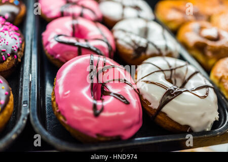 Schokolade rosa Eistee, Donuts und Weiße Zuckerglasur Stockfoto