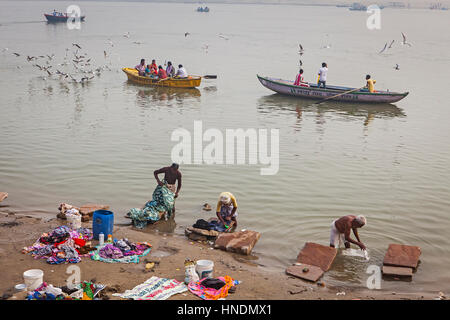 Landschaft, Panorama, Panorama, Arbeitnehmer, Wäsche waschen und im Hintergrund Pilger füttern Möwen, Ganges, Varanasi, Uttar Pradesh, Indien. Stockfoto