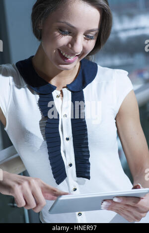 Geschäftsfrau, lächelnd und Tablet PC lesen Stockfoto