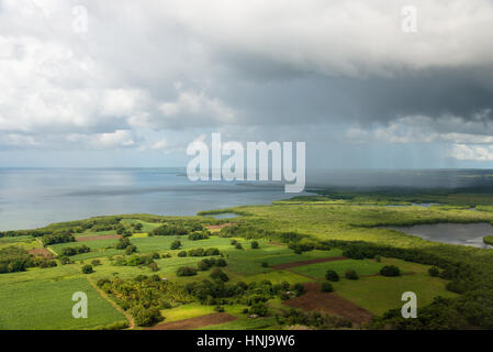 Vereinzelte Regenschauer mit Sonnenschein, Antenne Ansatz nach Guadeloupe in der tropischen Regenzeit Stockfoto