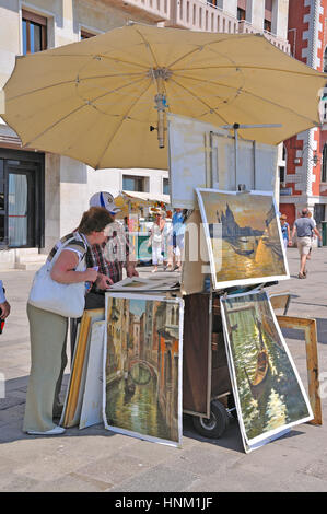 Straßenverkäufer verkaufen seine Kunst zu einem touristischen Hafen Venedig, Italien Stockfoto