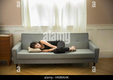 Frau düster auf sofa Stockfoto