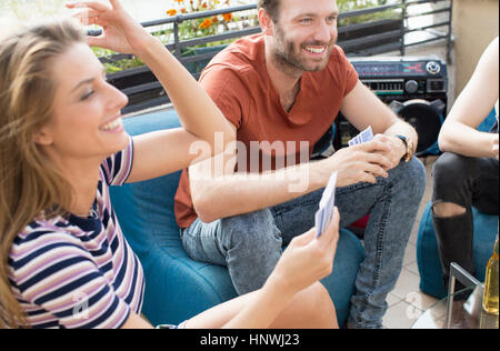 Junge Erwachsene Freunde Kartenspiele auf Dachterrasse party Stockfoto