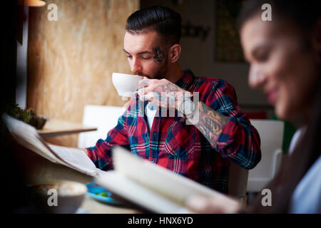 Paar, trinken Kaffee lesen Zeitungen Stockfoto