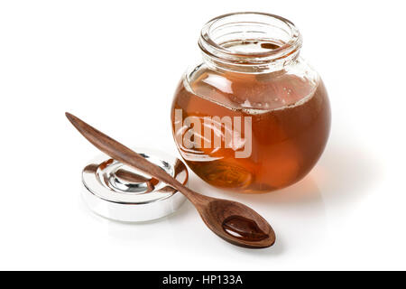 ein Glas mit Honig und Honig in hölzernen Tee-Löffel Stockfoto