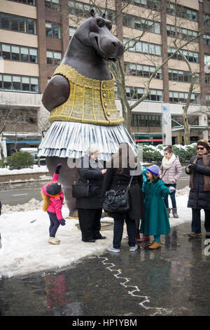 Passant Freude in die neu installierte 'Hippo Ballerina' Skulptur vom dänischen Künstler Bjørn Okholm Skaarup in Dante Park gegenüber dem Lincoln Center in New York am Samstag, 11. Februar 2017. Die 2 und eine halbe Tonne über 15 Fuß hohen Bronzeskulptur der tanzende Nilpferde in Disneys "Fantasia" Film und von Degas' Ballerina Gemälde inspiriert. Die beliebte Skulptur werden durch 31. Juli 2017. (© Richard B. Levine) Stockfoto