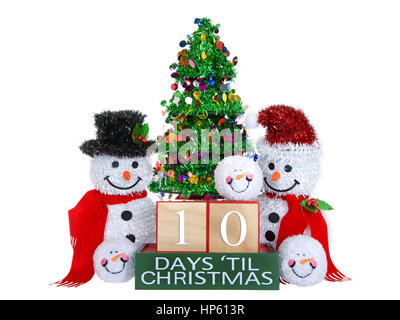 10 Tage bis Weihnachten hell Buche Holzblöcke mit roten Zierleisten auf einem grünem Sockel mit Lametta Weihnachtsbaum, Schneeball, Herr und Frau Schneemann Schneemänner-Kopf Stockfoto
