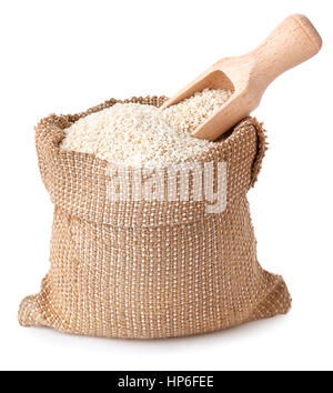 Sesam mit hölzernen Schaufel im Sack, die isoliert auf weißem Hintergrund. Volle Jute Beutel mit Sesam. Sesamsamen Stockfoto