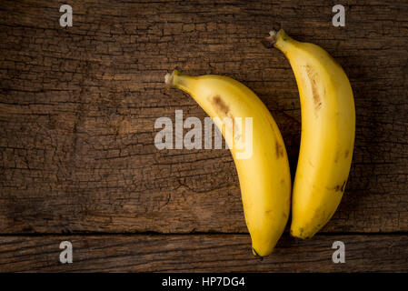 zwei reife Bananen auf Holztisch Stockfoto