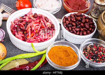 Salat aus Kohl, Karotten, Rüben und Butter in einer Holzschale, rote Bohnen. Studio Photo Stockfoto