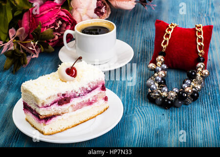 Stück Kuchen, Kuchen, Sahne, Kirschen, Schlagsahne auf blauem Hintergrund. Studio Photo Stockfoto